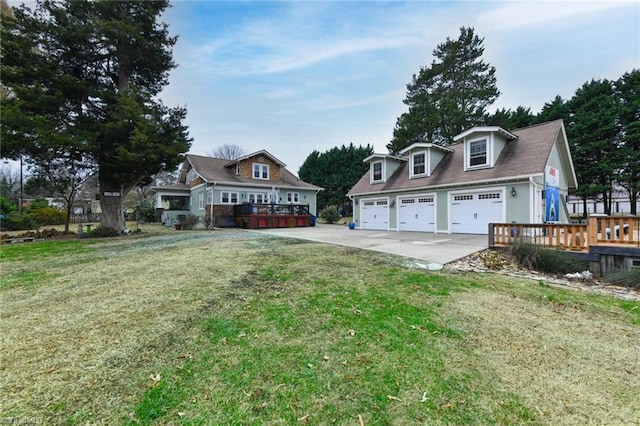 view of front of home featuring a wooden deck, a front lawn, and a garage