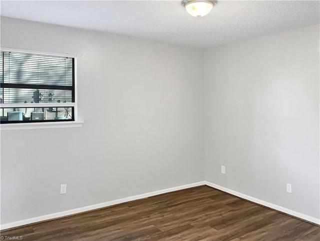 spare room featuring dark hardwood / wood-style floors