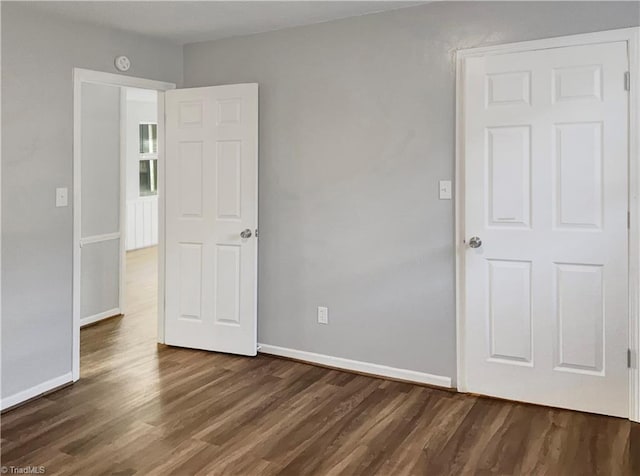 unfurnished bedroom featuring dark wood-type flooring