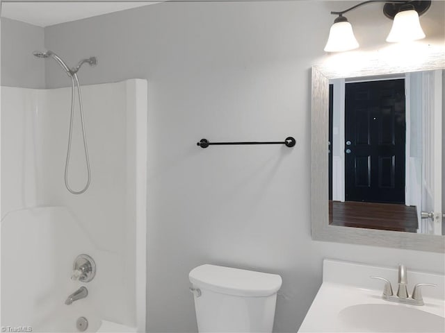 full bathroom featuring  shower combination, large vanity, and toilet