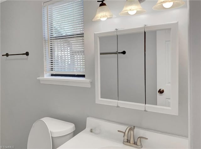 bathroom featuring vanity and toilet