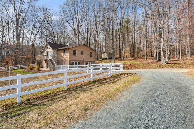 exterior space with driveway and a fenced front yard