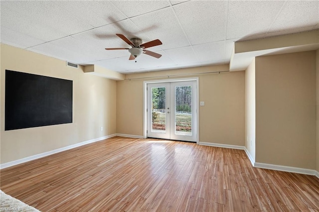 empty room with baseboards, french doors, visible vents, and light wood-style floors