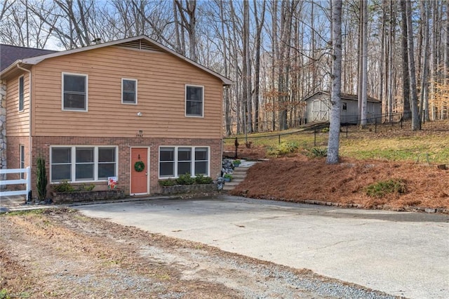 view of front of home with fence and brick siding