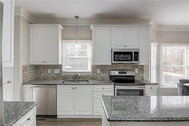 kitchen featuring a sink, ornamental molding, white cabinetry, and stainless steel appliances