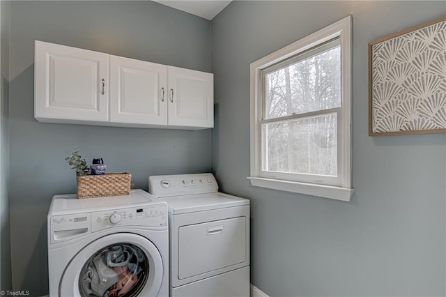 washroom featuring cabinet space and separate washer and dryer