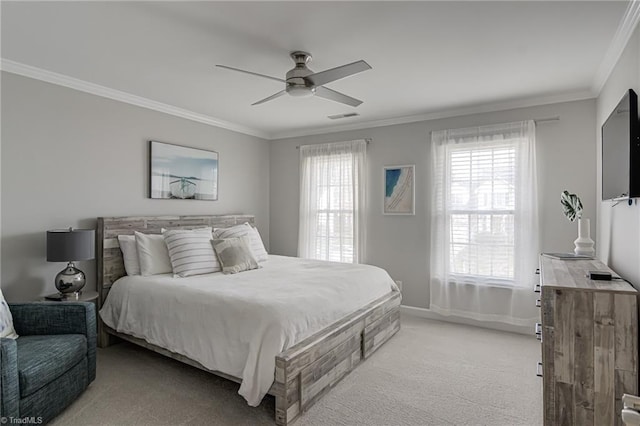 bedroom featuring a ceiling fan, visible vents, baseboards, crown molding, and light colored carpet