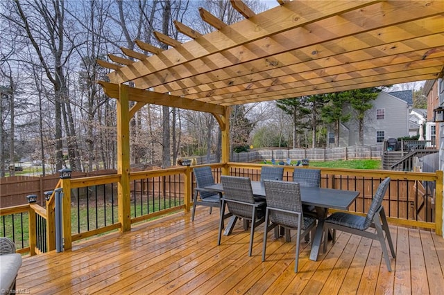 wooden terrace with a fenced backyard, outdoor dining space, and a pergola