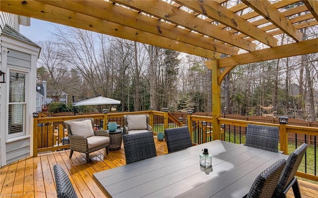 deck featuring outdoor dining space and a pergola