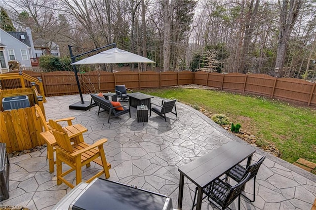 view of patio featuring an outdoor living space and a fenced backyard