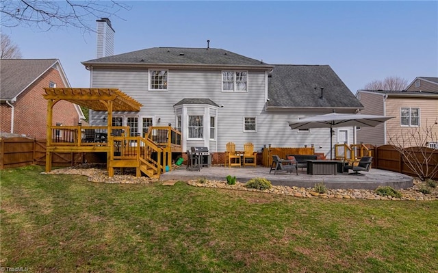 rear view of house featuring a yard, a patio, a fenced backyard, and a deck