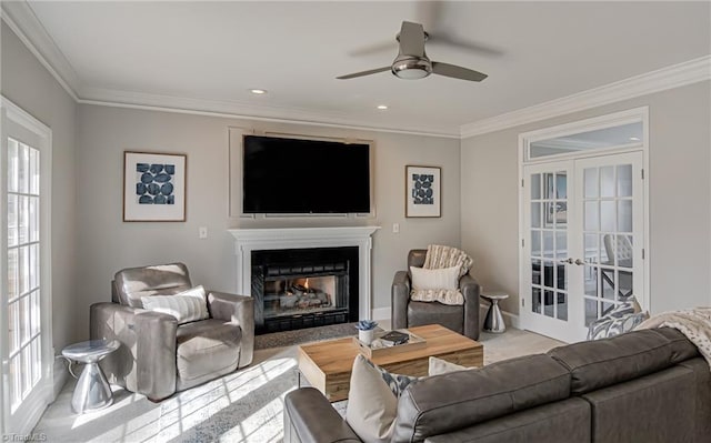 carpeted living area featuring a wealth of natural light, french doors, and ornamental molding