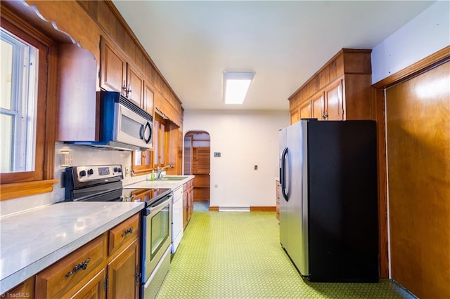 kitchen featuring sink, a baseboard radiator, and appliances with stainless steel finishes