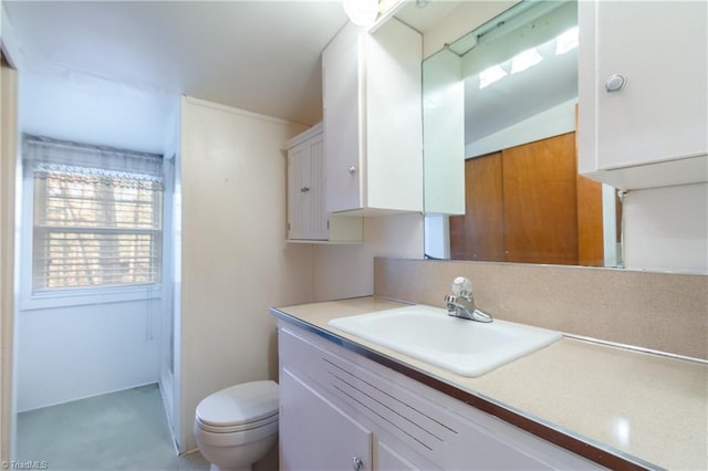 bathroom featuring vanity, toilet, and lofted ceiling