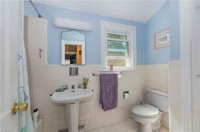 1414 Henri St, Mount Airy, NC 27030 - full bathroom featuring tile walls, tile patterned floors, wainscoting, toilet, and a shower with shower curtain