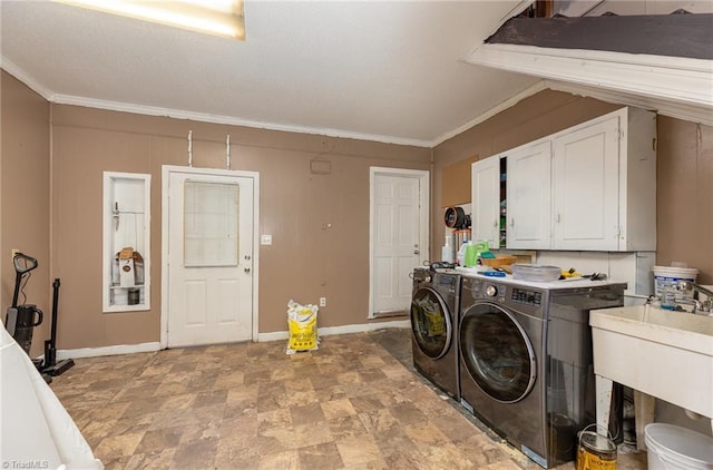 1414 Henri St, Mount Airy, NC 27030 - washroom featuring cabinet space, washing machine and dryer, baseboards, crown molding, and stone finish floors