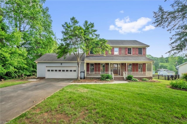 1323 Lancelot Ln, Graham, NC 27253 - colonial inspired home featuring a porch, a garage, driveway, and brick siding