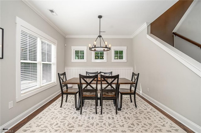 7634 Grapevine Rd, Lewisville, NC 27023 - dining area with an inviting chandelier, ornamental molding, and wood finished floors