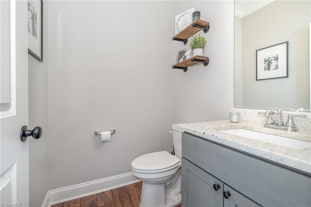 7634 Grapevine Rd, Lewisville, NC 27023 - half bathroom featuring crown molding, vanity, toilet, baseboards, and wood finished floors