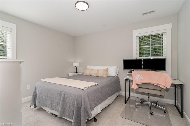 7634 Grapevine Rd, Lewisville, NC 27023 - bedroom with visible vents, baseboards, multiple windows, and light colored carpet