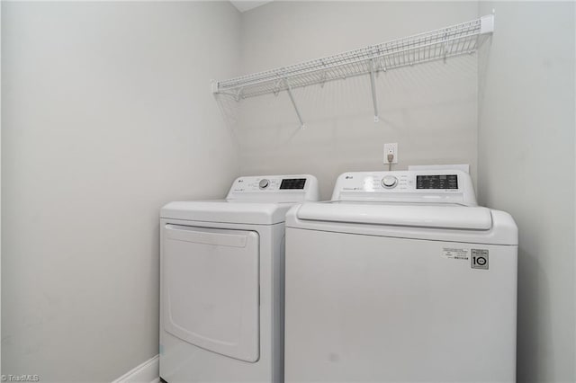 7634 Grapevine Rd, Lewisville, NC 27023 - laundry room featuring separate washer and dryer, baseboards, and laundry area