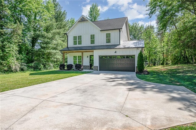 7634 Grapevine Rd, Lewisville, NC 27023 - modern inspired farmhouse featuring a front yard, a standing seam roof, board and batten siding, concrete driveway, and an attached garage