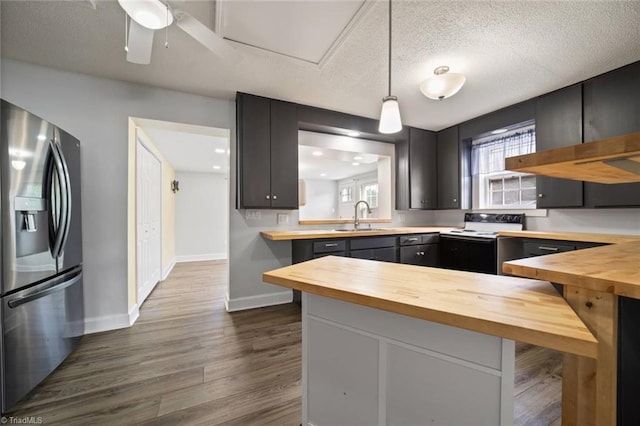 3231 Arlington Dr, Winston-Salem, NC 27103 - kitchen with wood counters, stainless steel refrigerator with ice dispenser, range with electric stovetop, dark wood-style flooring, and decorative light fixtures