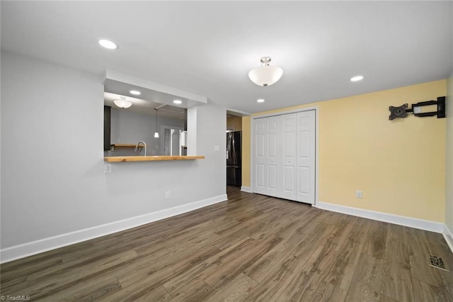 3231 Arlington Dr, Winston-Salem, NC 27103 - unfurnished living room with wood finished floors and recessed lighting