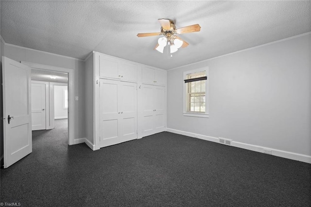 3231 Arlington Dr, Winston-Salem, NC 27103 - unfurnished bedroom featuring a textured ceiling, crown molding, dark carpet, a closet, and ceiling fan
