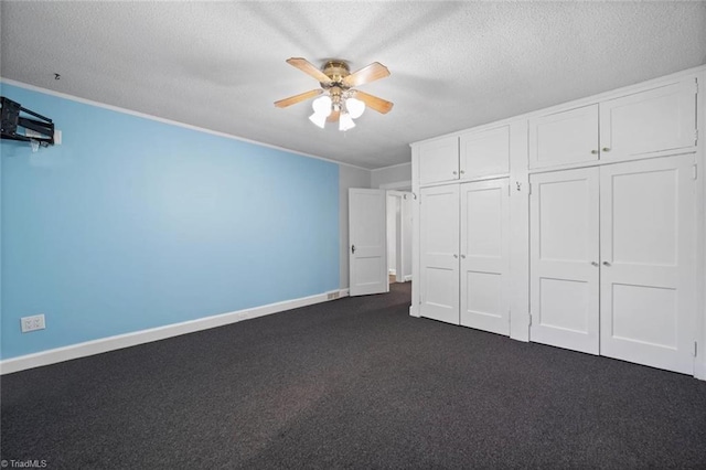 3231 Arlington Dr, Winston-Salem, NC 27103 - unfurnished bedroom featuring a textured ceiling, dark carpet, ceiling fan, a closet, and crown molding