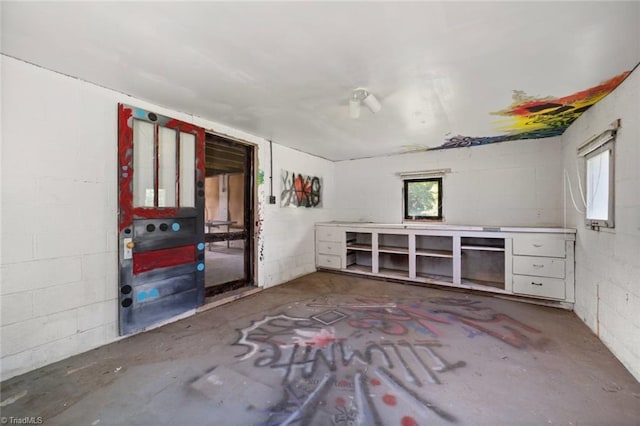 3231 Arlington Dr, Winston-Salem, NC 27103 - unfurnished room featuring concrete block wall, unfinished concrete floors, and plenty of natural light