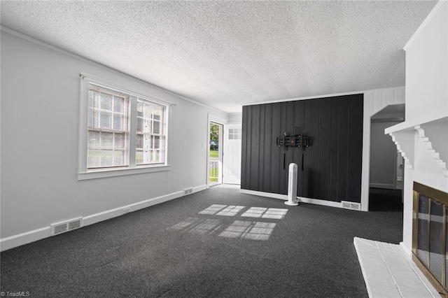 3231 Arlington Dr, Winston-Salem, NC 27103 - unfurnished living room with a textured ceiling, carpet floors, ornamental molding, and a glass covered fireplace