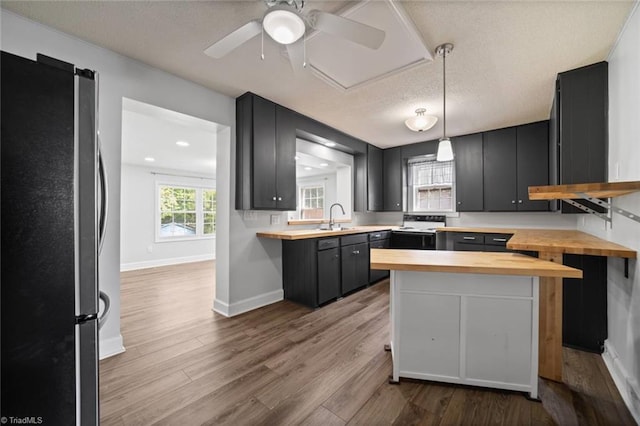 3231 Arlington Dr, Winston-Salem, NC 27103 - kitchen featuring butcher block counters, freestanding refrigerator, wood finished floors, a textured ceiling, and dark cabinets