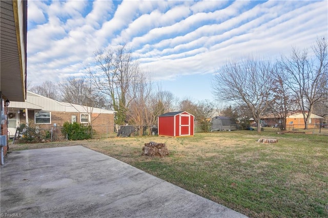 view of yard featuring a patio and a storage unit