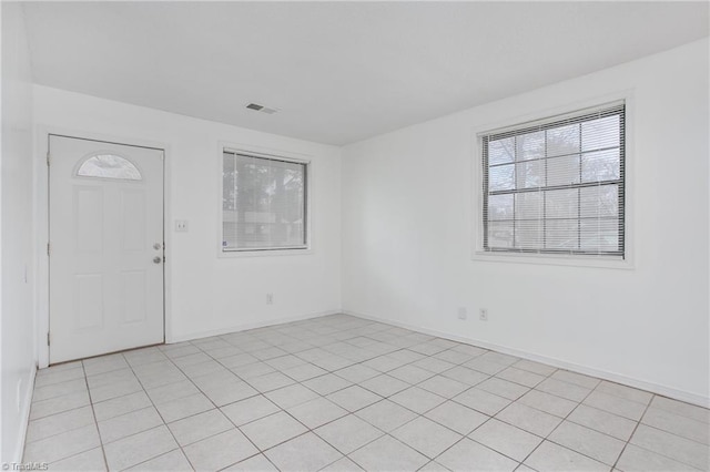 entryway with light tile patterned floors