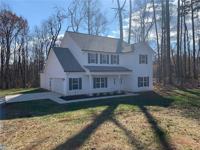 view of front of home with a front yard and a garage