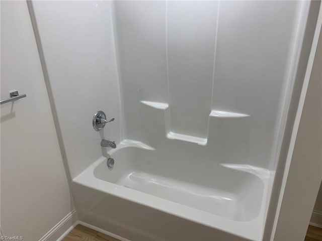 bathroom featuring shower / bath combination and hardwood / wood-style flooring