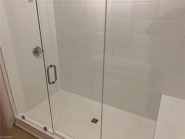 bathroom with a shower with shower door