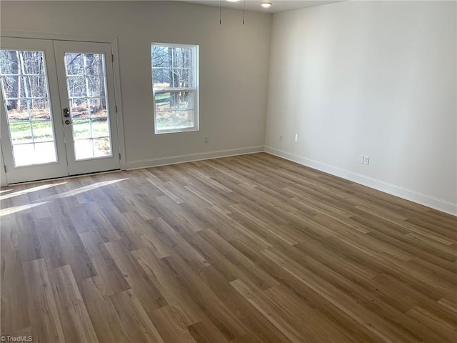 spare room featuring french doors and wood-type flooring