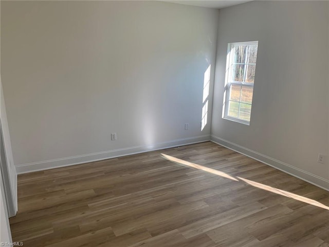 unfurnished room with dark wood-type flooring