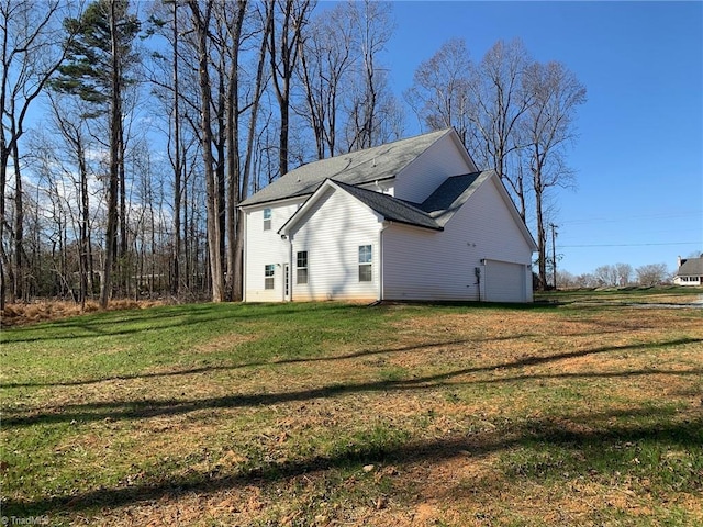 view of home's exterior featuring a lawn and a garage