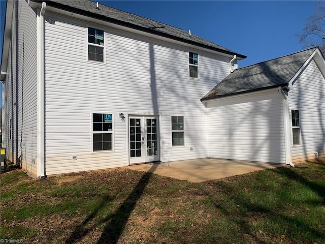 rear view of house featuring a yard, a patio, and french doors