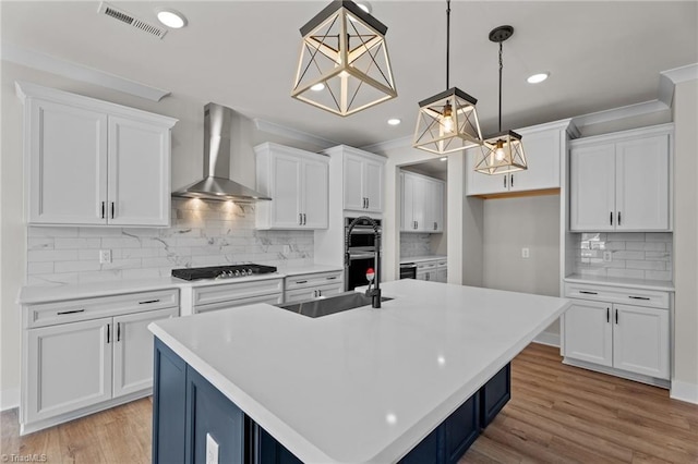 271 Redland Rd, Advance, NC 27006 - kitchen with wall chimney range hood, decorative backsplash, white cabinets, light countertops, and recessed lighting