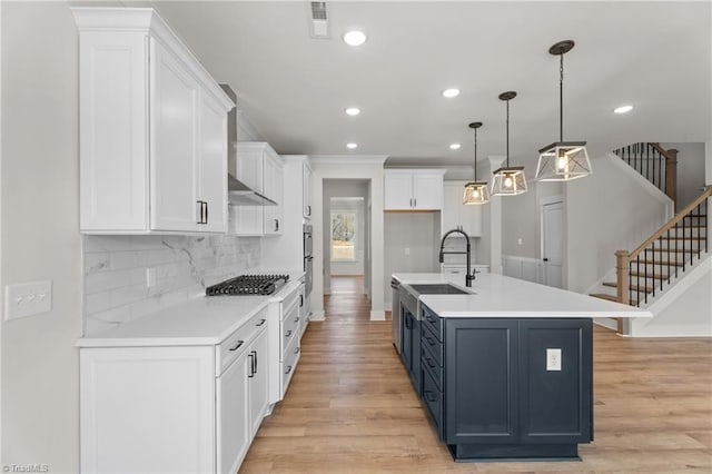 271 Redland Rd, Advance, NC 27006 - kitchen with stainless steel gas stovetop, white cabinetry, light wood-style flooring, recessed lighting, and crown molding
