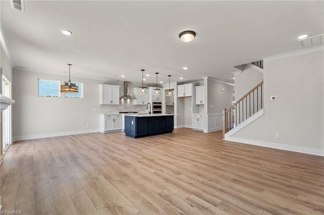 271 Redland Rd, Advance, NC 27006 - unfurnished living room with light wood finished floors, crown molding, stairs, and recessed lighting