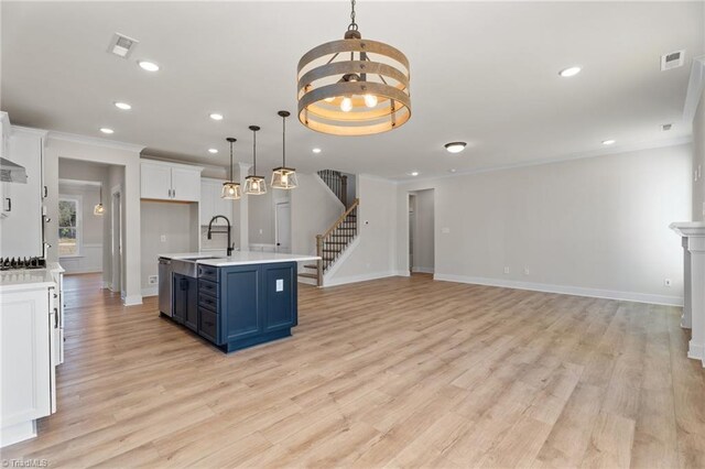 271 Redland Rd, Advance, NC 27006 - kitchen featuring light countertops, a chandelier, white cabinetry, light wood-type flooring, and ornamental molding