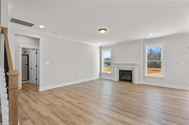 271 Redland Rd, Advance, NC 27006 - unfurnished living room with ornamental molding, light wood-type flooring, stairway, healthy amount of natural light, and a glass covered fireplace