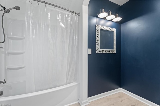 bathroom with hardwood / wood-style floors and shower / bath combination with curtain