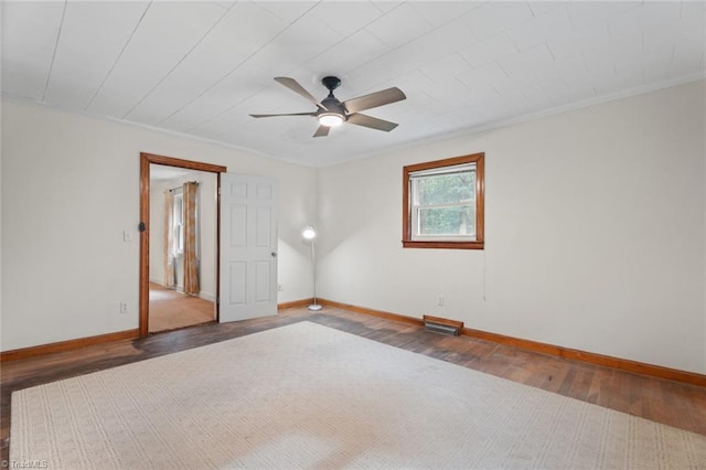 unfurnished room featuring ornamental molding, dark hardwood / wood-style flooring, and ceiling fan