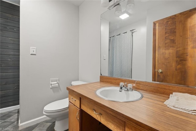 bathroom featuring vanity, toilet, and tile patterned floors